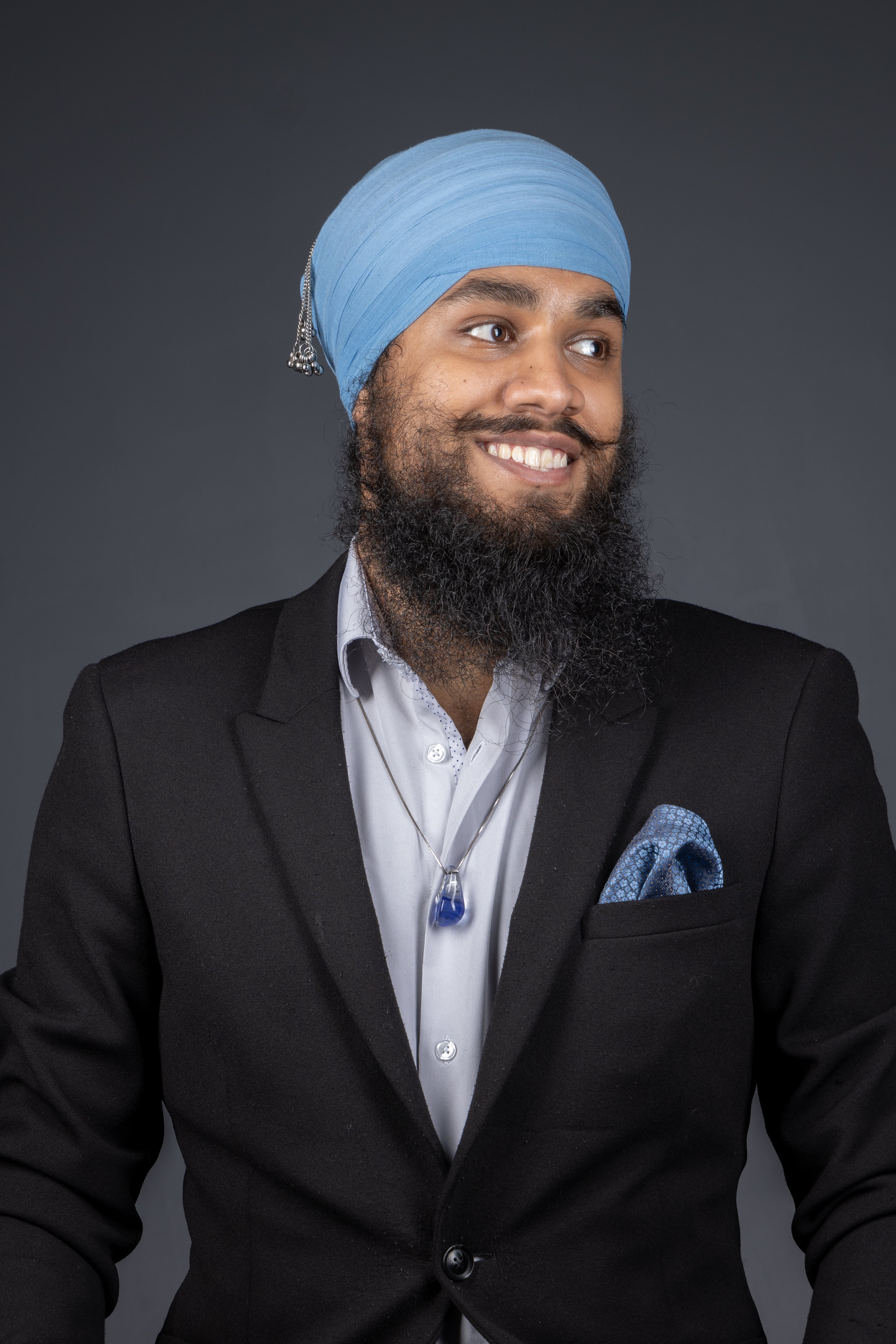 Kunwarbir wearing a light blue turban and black suit